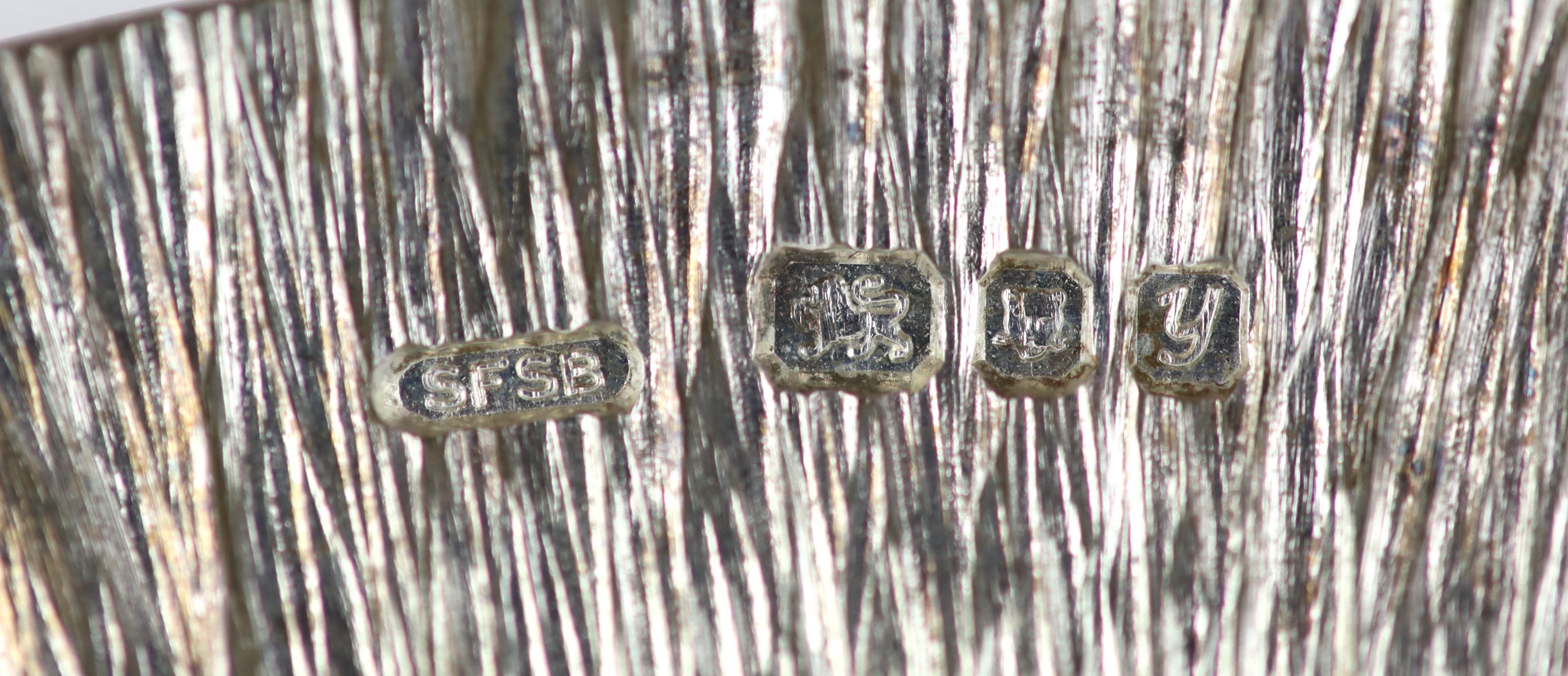 A silver small circular dish, by Simon Benney, maker's mark SFSB, London, 1998, the base stamped 'Benney'